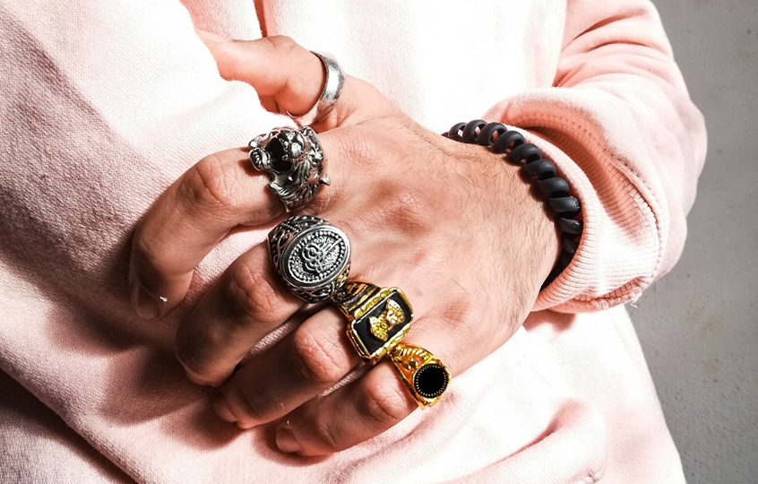 A man wearing the stainless steel, sterling silver and gold rings-Gthic.com