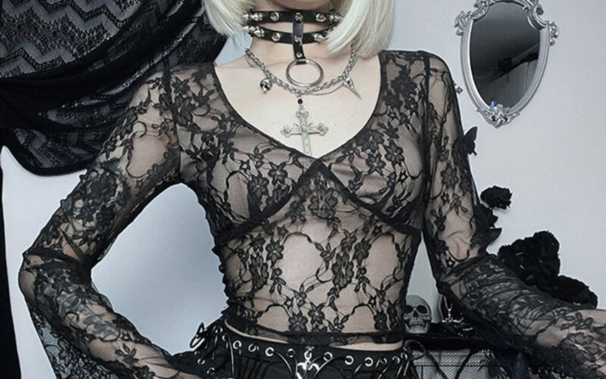 A woman in a set of gothic clothes wears a gothic necklace pendants