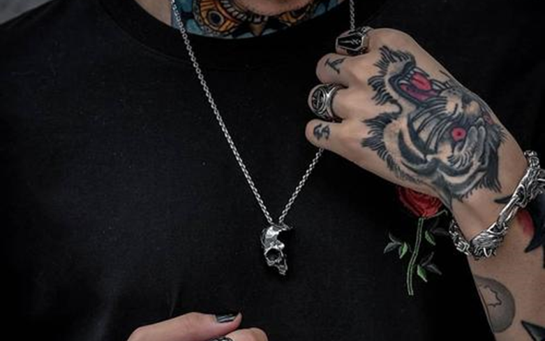 A man wear a gothic skull pendant