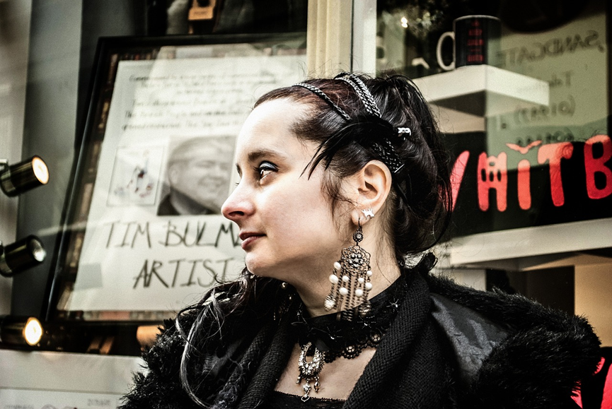 A woman wearing a big earring in gothic fashion - Gthic.com