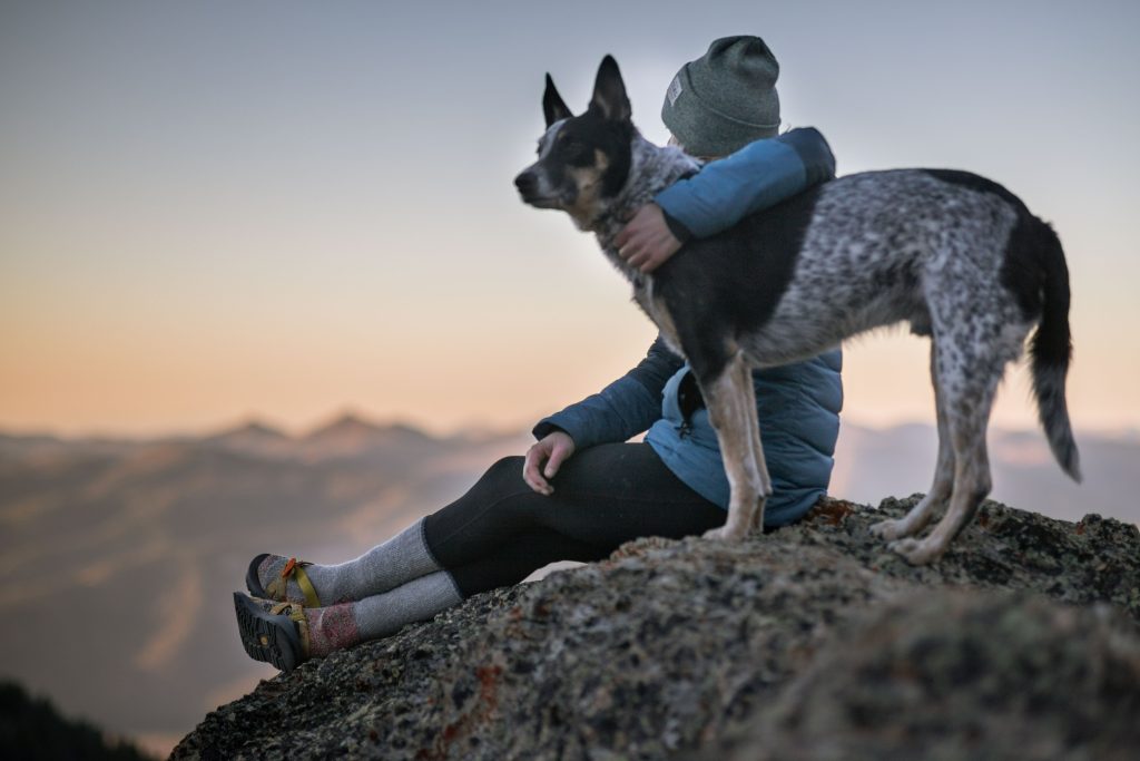 woman and a dog on the hill