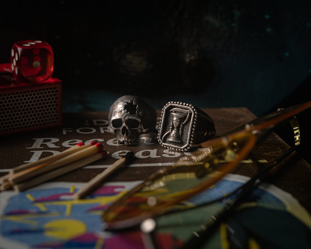 skull-ring-and-matches-on-a-book-beside-glasses