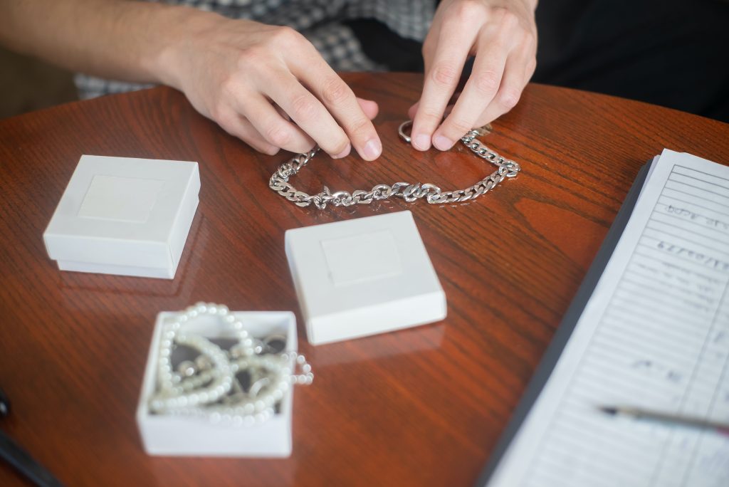 a-person-holding-chain-necklace