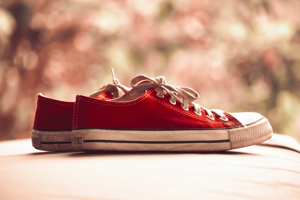 pair-of-red-low-top-sneakers-in-bokeh-photography