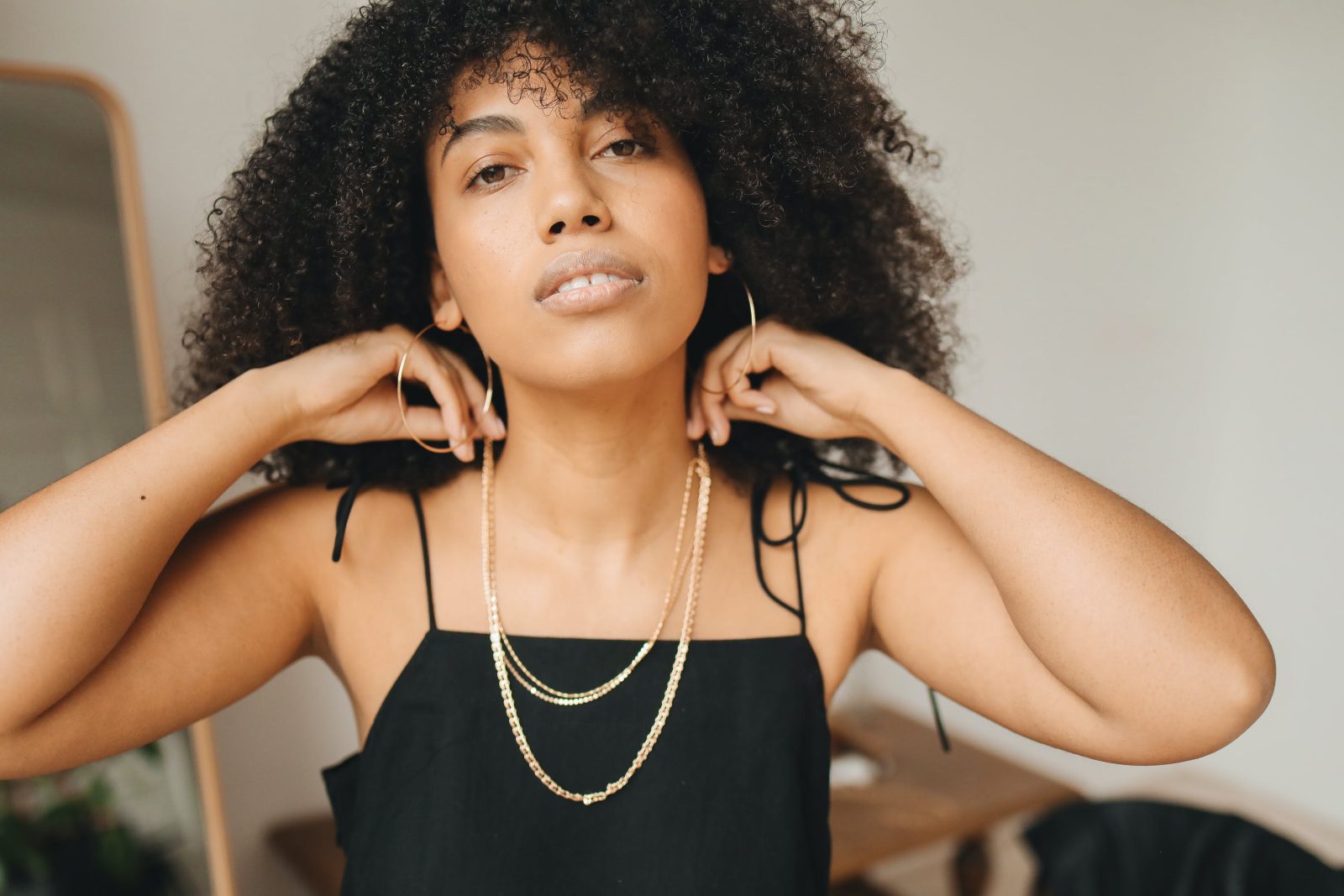 woman-in-black-spaghetti-strap-top-wearing-necklace