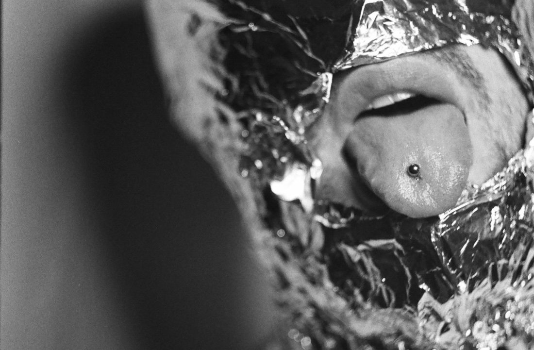 a man with tongue piercings