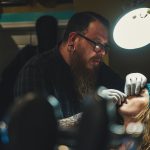 a man doing nose piercing